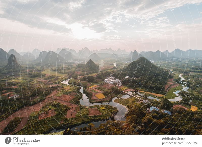 Coastal town surrounded with rocky mountains seaside coast travel bay remote drone view tourism architecture aerial green scenic small nature vacation beach