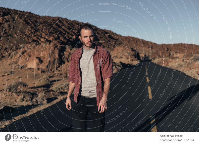 Man walking on mountain road on Tenerife Island man desert sunset solitude tenerife spain road trip young male handsome journey alone leisure wild nature travel