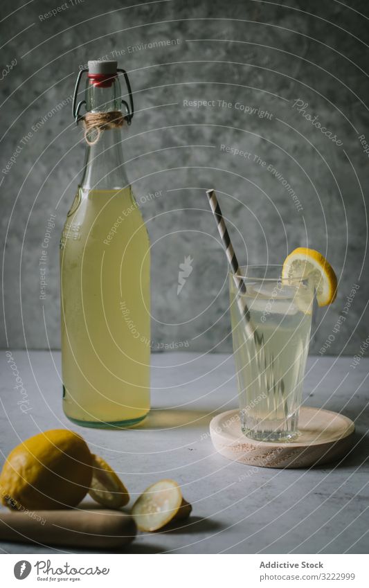 Delicious elderflower syrup in glass and bottle homemade citrus lemon fruit beverage drink refreshment cold delicious tasty liquid straw served cooked prepared
