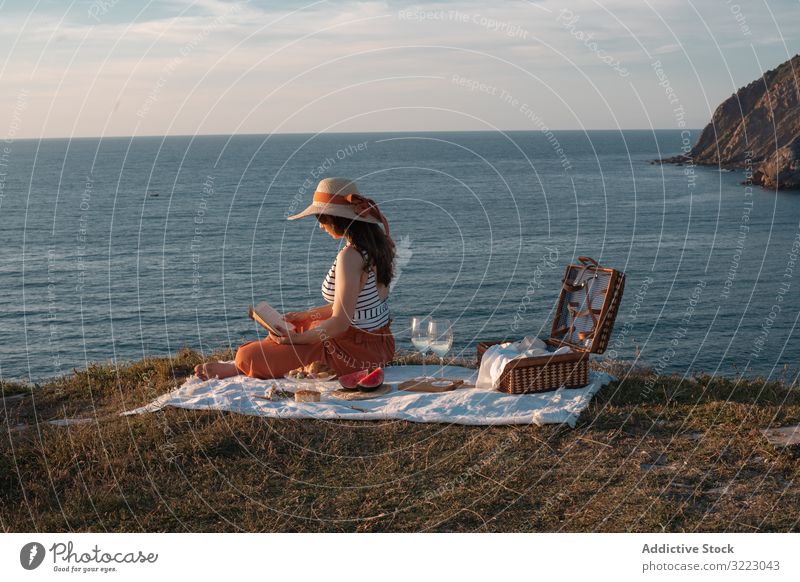 Woman reading on mat for picnic on seashore woman book seaside beach summer leisure sky relax glass drink vacation summertime vintage fashion refreshing