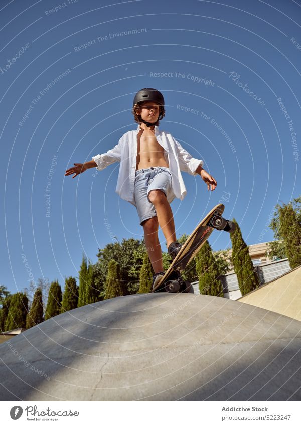 Child on ramp ready to show skateboard trick child skatepark ride sport leisure hobby boy hands apart young scream carefree childhood summer sunny active fun
