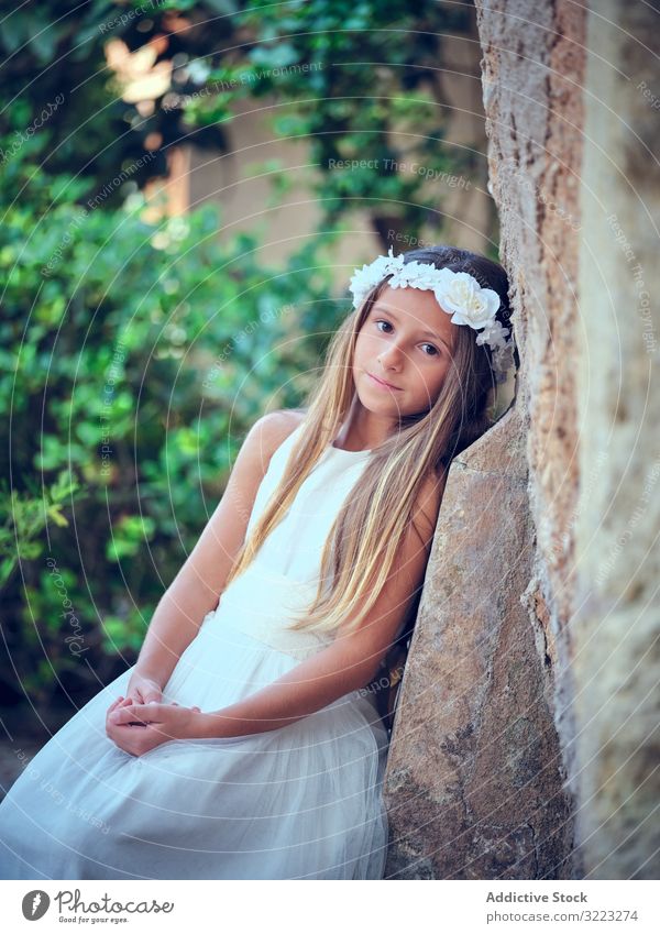 Little cute girl in white dress and flower headband child beautiful little adorable kid innocence pensive female purity individuality comely sweet hair positive