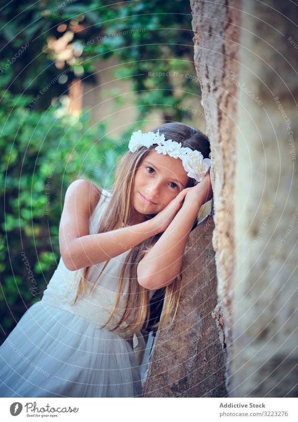 Little cute girl in white dress and flower headband child beautiful little adorable kid innocence pensive female purity individuality comely sweet hair positive