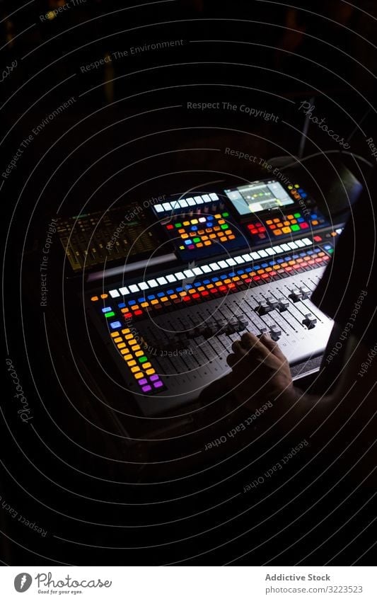 Sound mixer during a night concert man switch buttons volume digital electronic panel equalizer media board technology audio professional control equipment