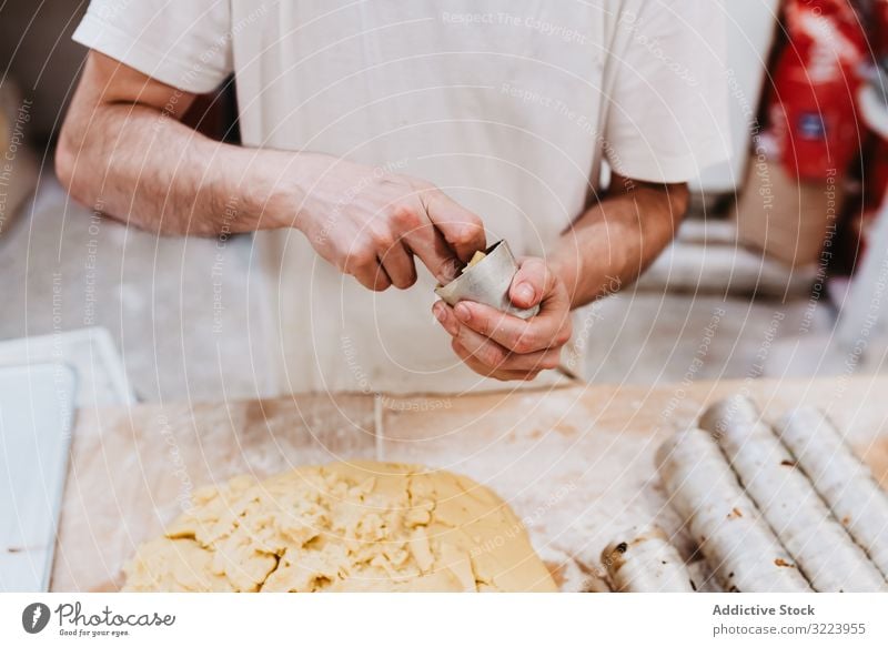 Unrecognizable cook putting pastry dough in cup confectioner bakery table kitchen preparation fresh man raw cuisine professional food chef restaurant cafe flour