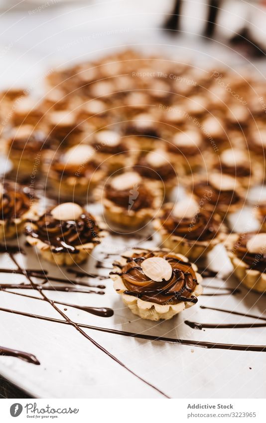 Delicious desserts with nuts and caramel chocolate cream sauce tart food sweet ingredient syrup pastry meal bakery paper parchment set many delicious tasty
