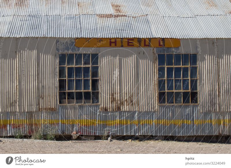 H E L L L Hut Industrial plant Building Facade Metal Rust Characters Signage Warning sign Line Old Creepy Broken Retro Trashy Yellow Gray White Crisis