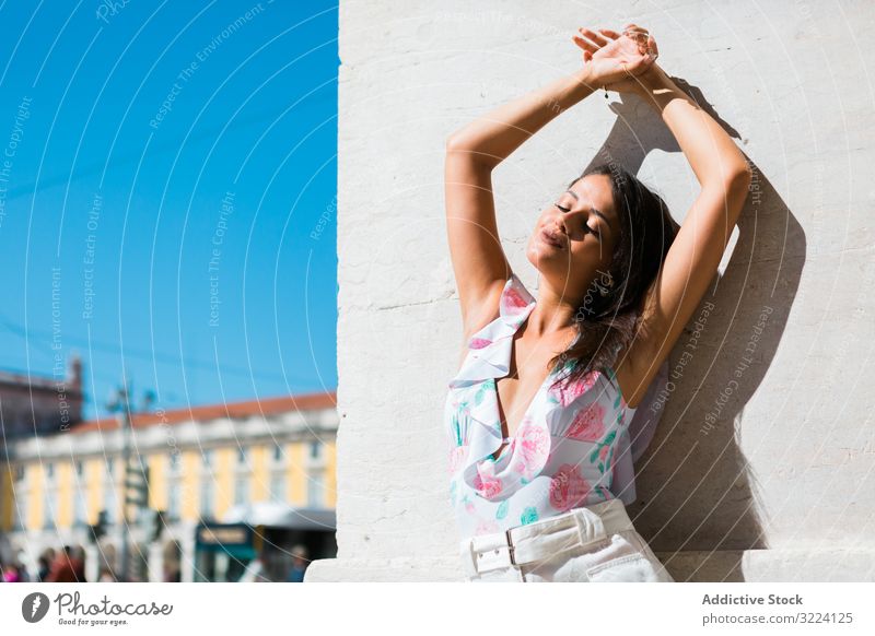 Dreamy stylish woman standing on city street dreamy trendy beautiful building portugal accessory lisbon pattern young adult exotic pensive authentic tiled urban