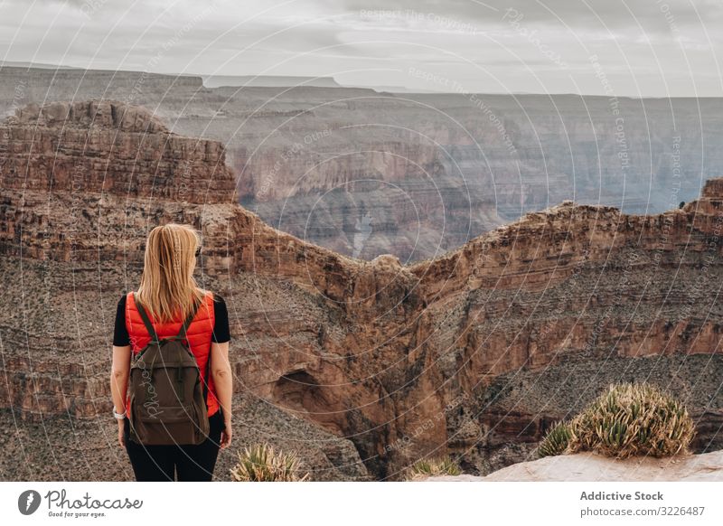 Calm female looking at pictorial landscape woman admire canyon view picturesque calm backpack usa vacation explore holiday tourist freedom carefree travel