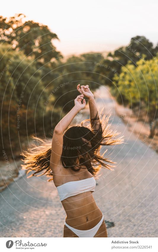 Woman in underwear and sneakers squatting on rural road woman nature tender lingerie slender countryside hide scared body white sunset natural gentle kneeling