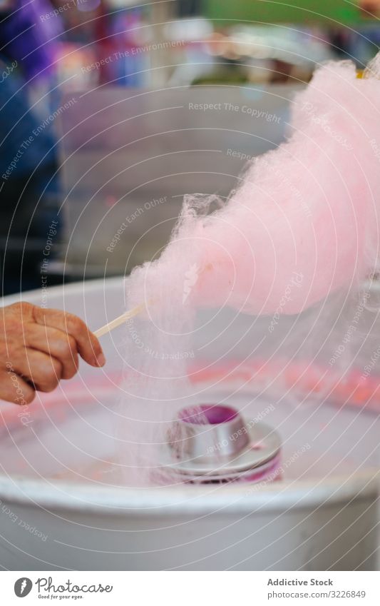 Making of cotton candy at amusement park vendor make process delicious pink pastel sweet funfair fairground entertainment food carnival snack diet tasty