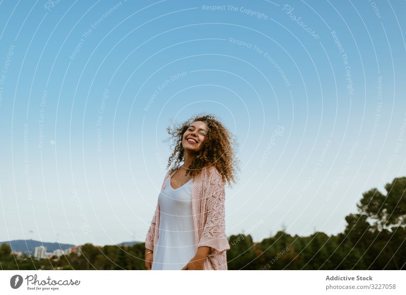 Happy woman raising arms to sky happy closed eyes nature freedom summer weekend peaceful female elegant vacation joy carefree calm tranquil serene harmony