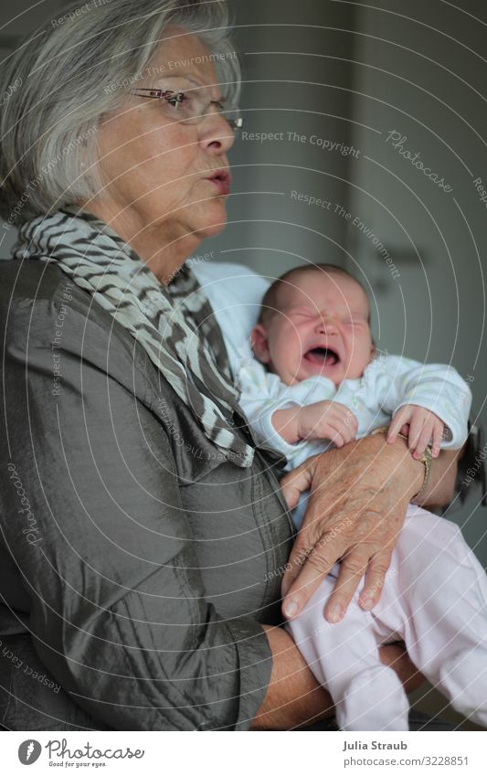 Chic granny with grey hair holds screaming babe in her arms Feminine Baby Woman Adults Female senior 2 Human being 0 - 12 months 45 - 60 years Jacket Silk