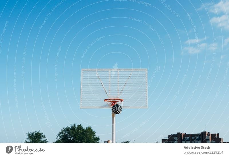 ball into basket in Outdoor basketball court and black ball man athlete competition sports equipment adult recreation action portrait active activity asphalt