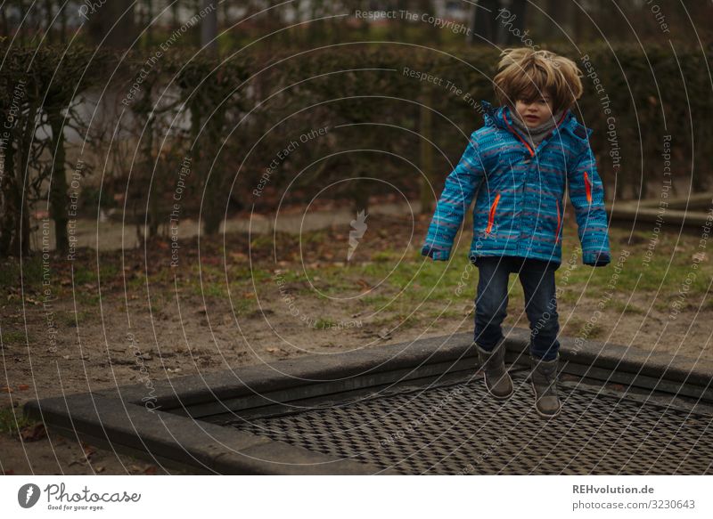 Boy jumps on a trampoline Forward Full-length Shallow depth of field blurriness Day Exterior shot Colour photo Dynamics Action Flying Trampoline Hop