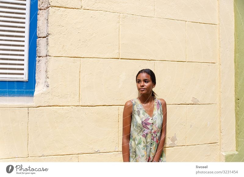 Young Cuban girl leaning on a wall in Havana, Cuba Lifestyle Happy Island Human being Feminine Young woman Youth (Young adults) Woman Adults Body Head Face Eyes