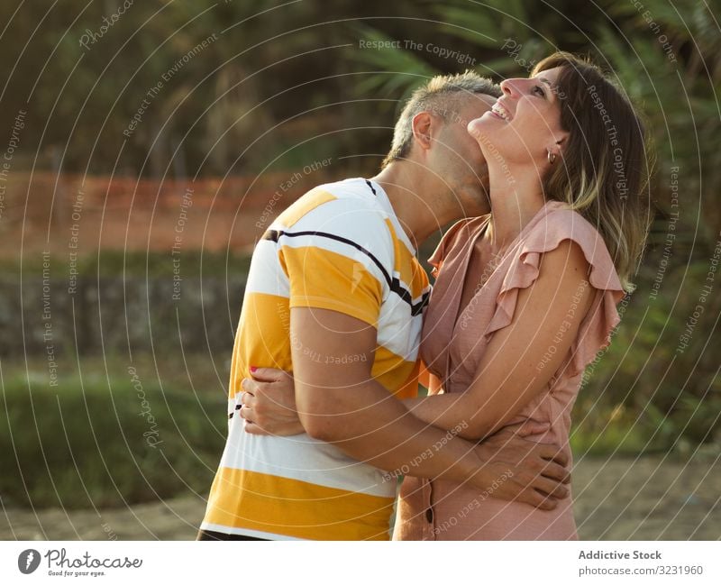 Happy couple looking at each other love smile happy vacation sunny daytime man woman adult honeymoon summer nature shore coast relationship holiday tropical