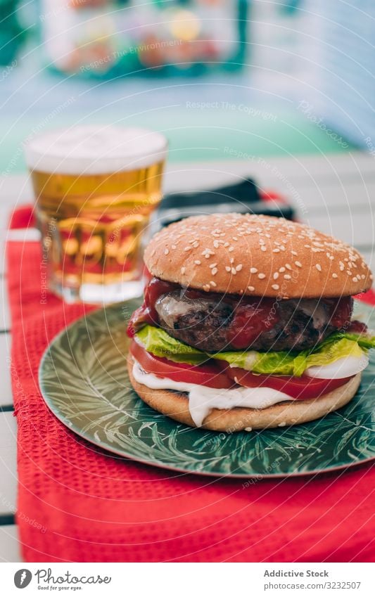 Cheeseburger with lettuce and tomato bun classic unhealthy table food meal cheeseburger onion beef delicious bbq grill snack hamburger american gourmet beer