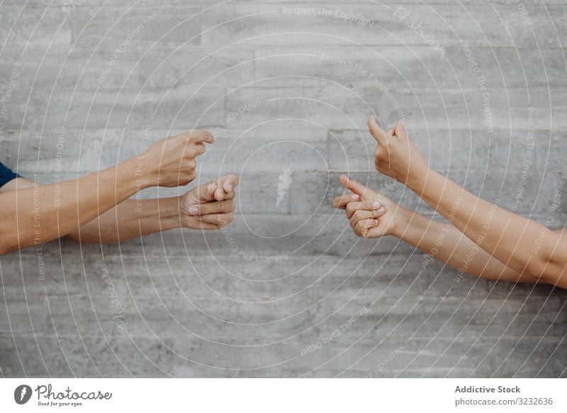 Hands gesturing music on background of grey wall gesture opposite dislike finger thumb success creative choose upset happy hand positive confident concept