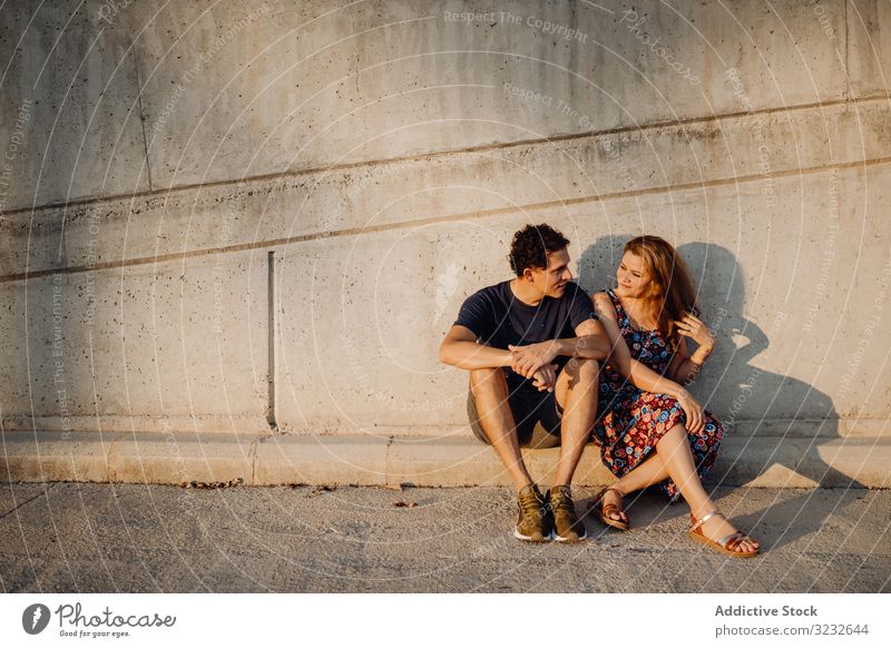3232644 man and woman sitting at nearby street wall couple photocase stock photo large
