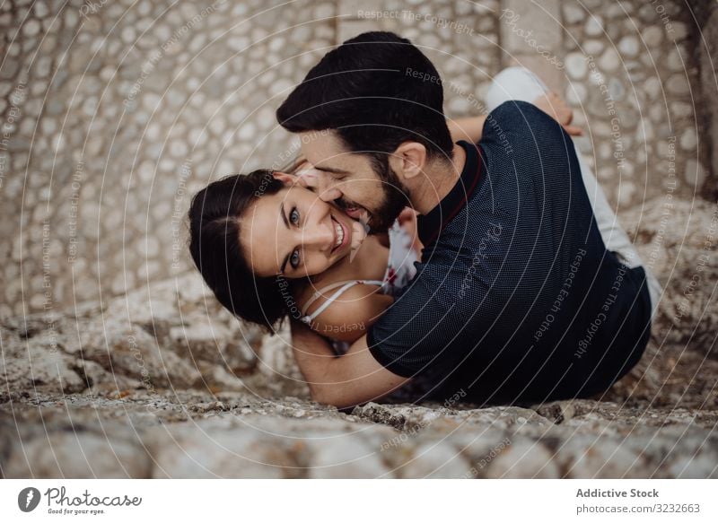Photo of Romantic couple portrait with groom kissing bride on forehead