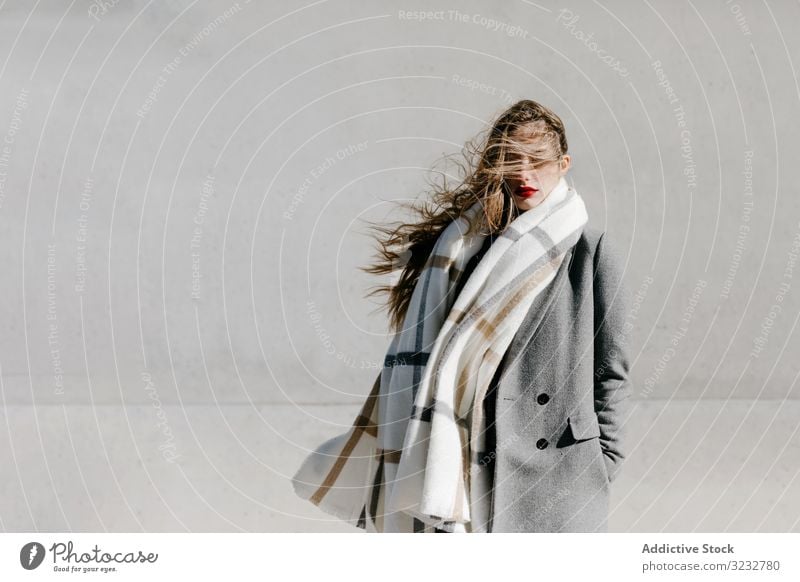 Young woman in coat and scarf on windy day - a Royalty Free Stock Photo  from Photocase