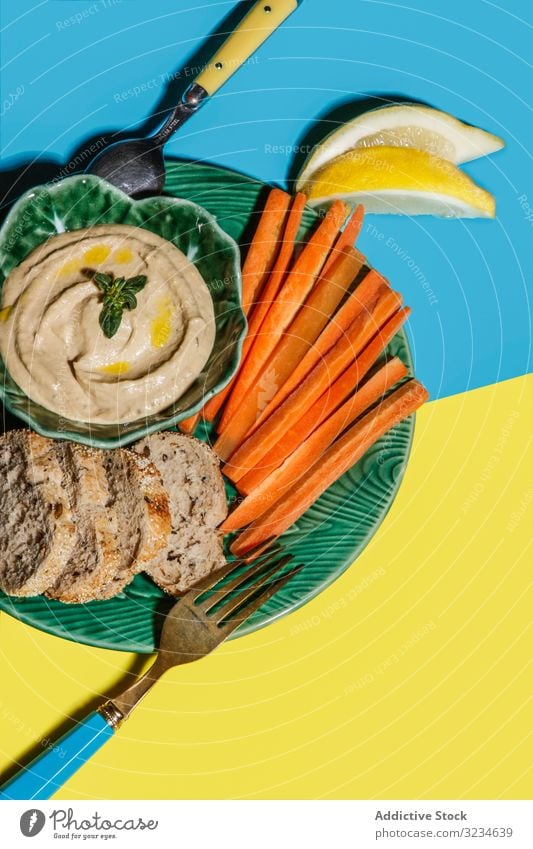 Tasty healthy snack of carrot with bread and sauce appetizer dip dish toast platter food served fresh hummus pea crisp vegetable dinner ingredient organic lemon