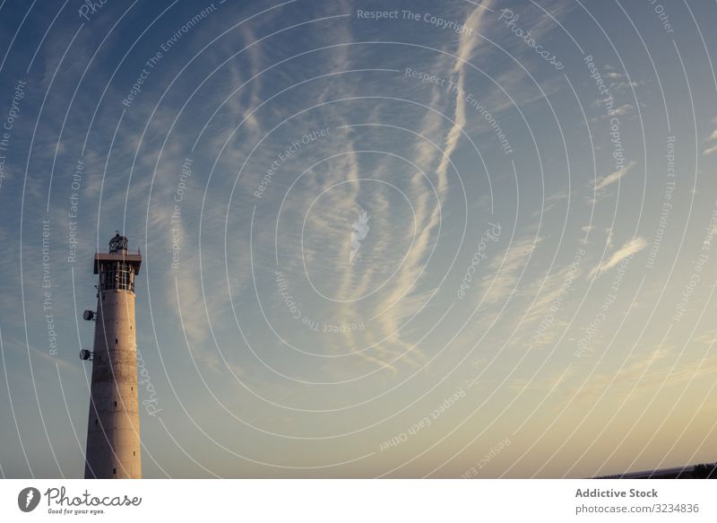 Round grey lighthouse tower rising up to sky round ocean nature architecture nautical beach breathtaking cloud travel tide las palmas fuerteventura spain