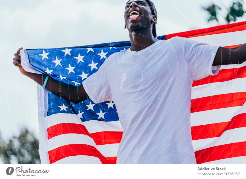 Black man wrapping in American Flag outside american flag wrapped black african american national independence active 4th of july banner celebrating freedom