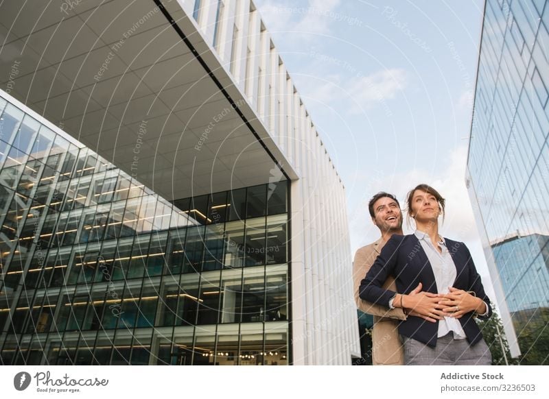 Businesspeople couple outside contemporary building businesspeople street walk work smile man woman colleague together coworker office city town urban modern
