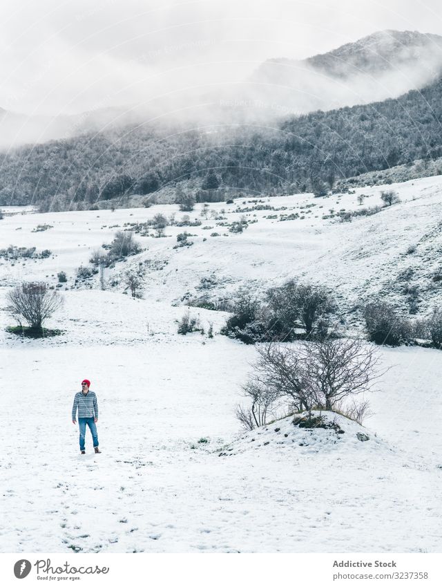 Man walking on winter field man snow relaxation enjoy country forest recreation alone meadow hill tree frozen quiet calm tranquil cold nature valley journey