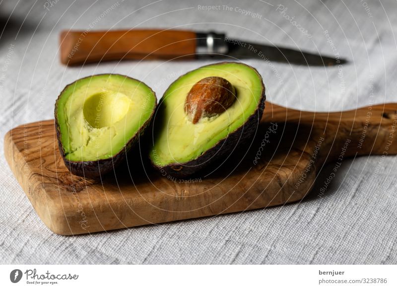 Avocado with core on a wooden board - a Royalty Free Stock Photo from  Photocase