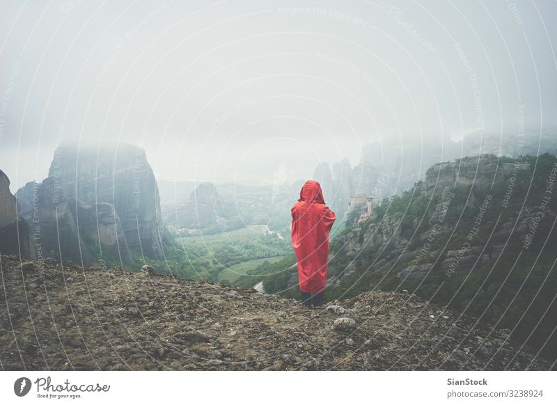 Woman with red raincoat on landscape of Meteora rocks, Greece Beautiful Vacation & Travel Tourism Summer Mountain Hiking Adults Culture Nature Landscape Sky Fog