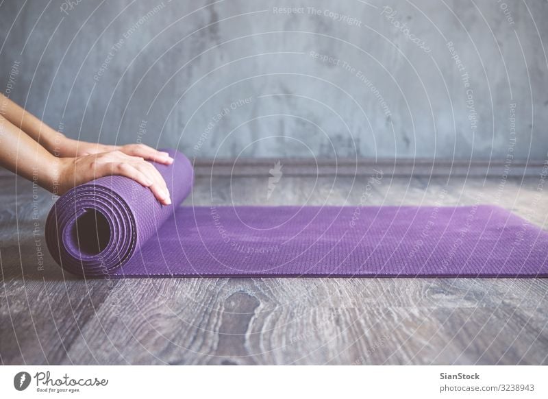 Woman rolling her mat after a yoga class Lifestyle Beautiful Body Relaxation Meditation Sports Yoga Human being Adults Fitness Thin young Practice pose workout