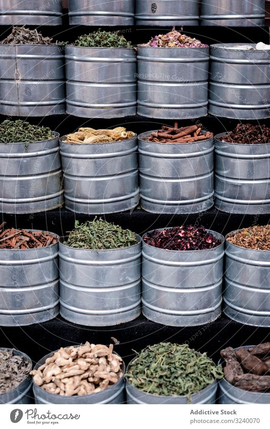 Metal containers with herbs spice market stall jar sell dry traditional assortment marrakesh morocco bazaar arabic city town trade aroma sale street marketplace