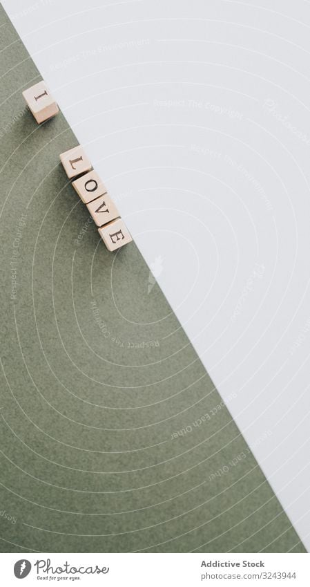 Inscription laid out with wooden cubes on contrasting surface message inscription composition i love sign concept simple white green letter geometric romantic