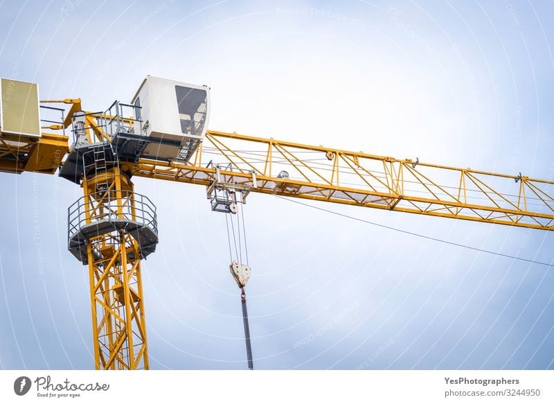 Yellow tower crane close-up. Crane at a construction site Construction site Machinery Construction machinery Building Architecture Steel Tall Strong Action