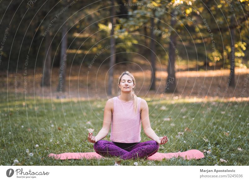 Young woman doing yoga in the park Lifestyle Athletic Fitness Wellness Harmonious Relaxation Meditation Yoga Human being Feminine Youth (Young adults) Woman