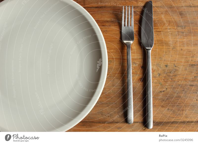 Empty dish on a wooden table. Crockery Cutlery Knives Fork Lifestyle Style Healthy Healthy Eating Fitness Overweight Wellness Well-being Meditation