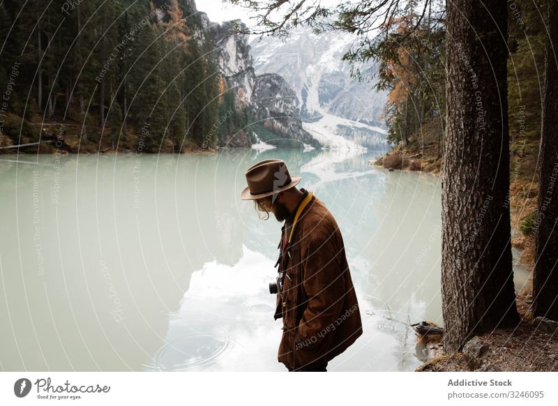 Man delighting in views near lake and mountains tourism water boat fog cloudy mist travel landscape vacation adventure nature beautiful sky scenic holiday rock