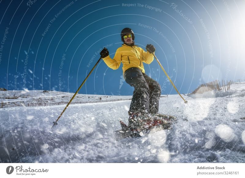 Man skiing on winter day man ride slope snow resort extreme outwear sunglasses cold sport vacation lifestyle recreation frost male cool sunny daytime activity