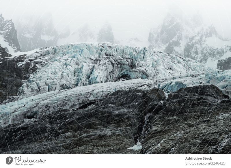 Gray Rocky Mountains With Snow Under Foggy Mist A Royalty Free Stock Photo From Photocase