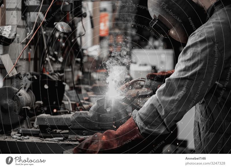 welder is welding metal part in garage. with protective mask, Work and employment Profession Workplace Factory Industry Tool Technology Man Adults Metal Steel