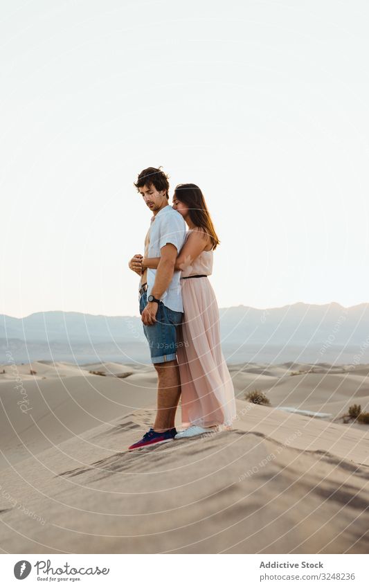 Tender couple hugging in sandy desert valley intimate tender lovely landscape nature tourist relationship romantic travel together adventure traveler journey