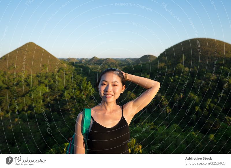 Happy woman standing on observation deck on hill fence young happy adventure smile tourist female ethnic asian cheerful joyful green mountain hike nature
