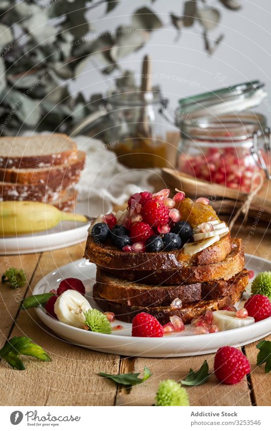 Honey pouring over fried toasts with fruit french honey stack spill french toast table mint breakfast morning food dessert snack treat portion sauce sweet