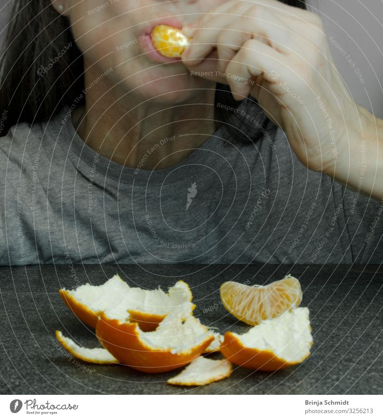 A Woman Shoves A Piece Of Tangerine Into Her Mouth A Royalty Free