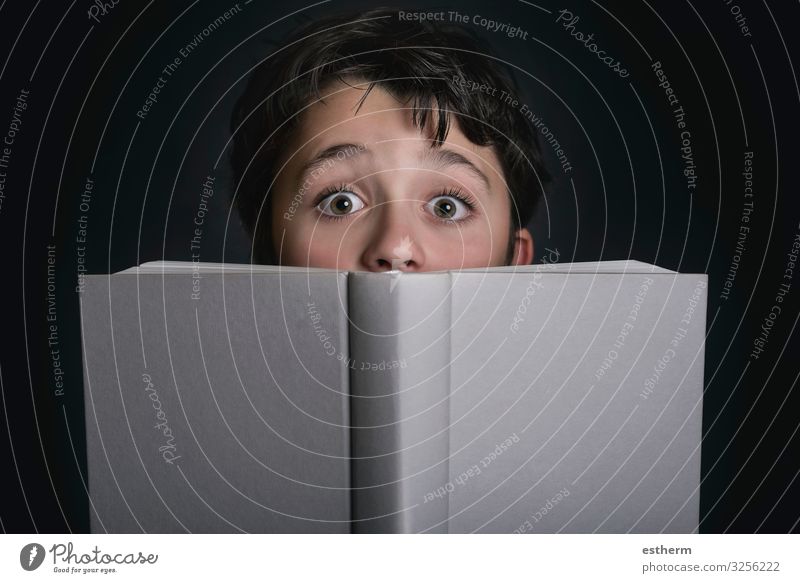 curious child with book on black background Lifestyle Playing Reading Child School Schoolchild Human being Masculine Infancy 1 8 - 13 years Book Paper Think