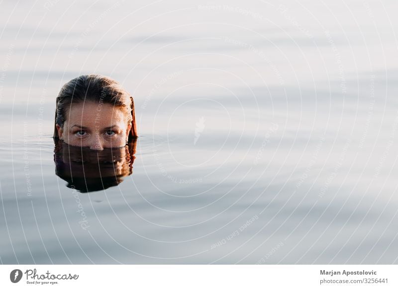 Young woman in the sea in sunset light Lifestyle Joy Vacation & Travel Tourism Summer Summer vacation Ocean Human being Feminine Youth (Young adults) Woman