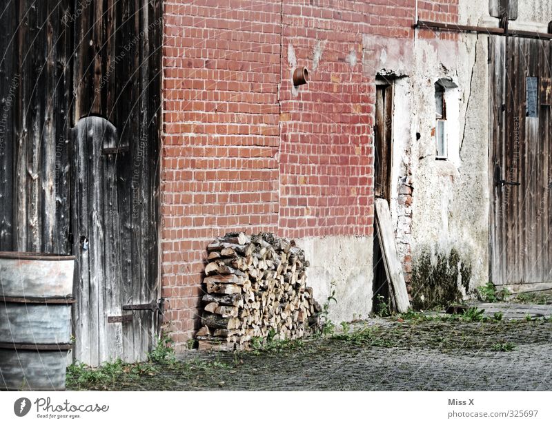 Wood in front of the hut Living or residing Flat (apartment) Village Deserted Old Farm Firewood Stack of wood Barn Barn door Brick wall Courtyard Colour photo